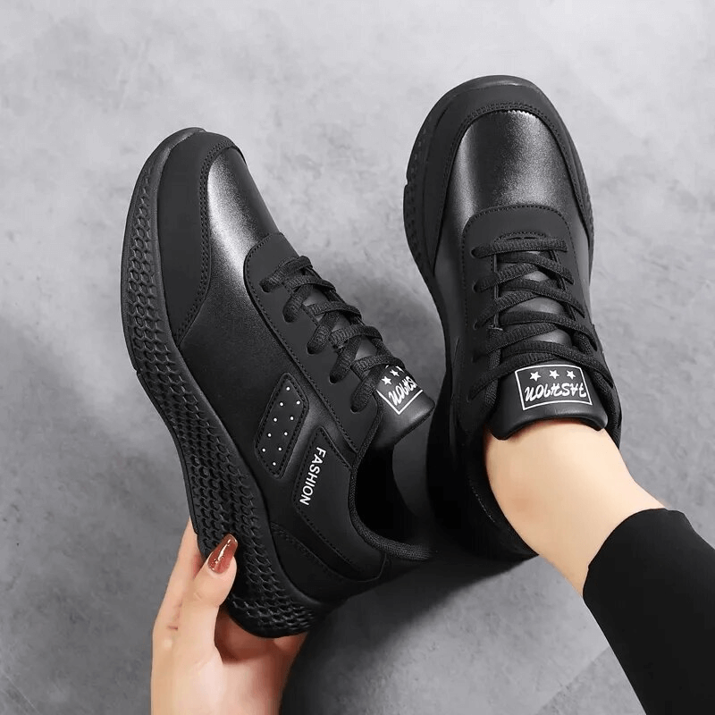 Sleek black non-slip women's running shoes with a breathable mesh upper and durable PVC outsole for ultimate comfort and grip.